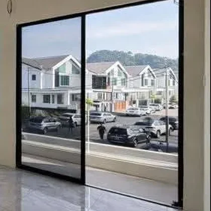 Hills seen through the sliding door of a completed Pulai Height bedroom, real photograph